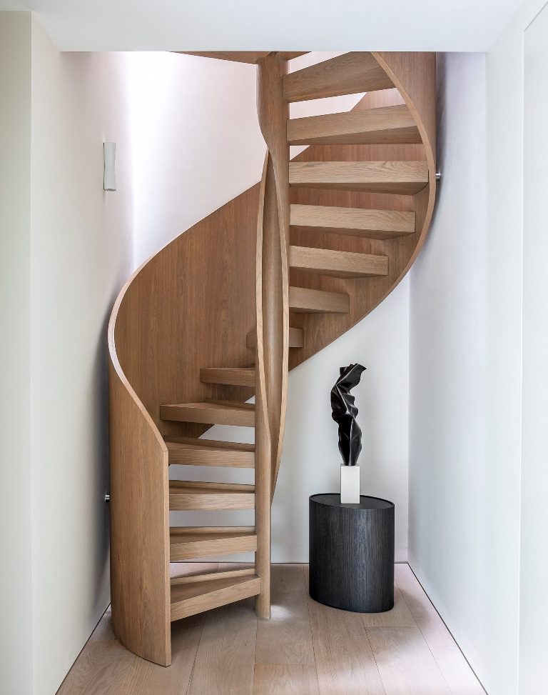 A helical staircase connects the three floors
