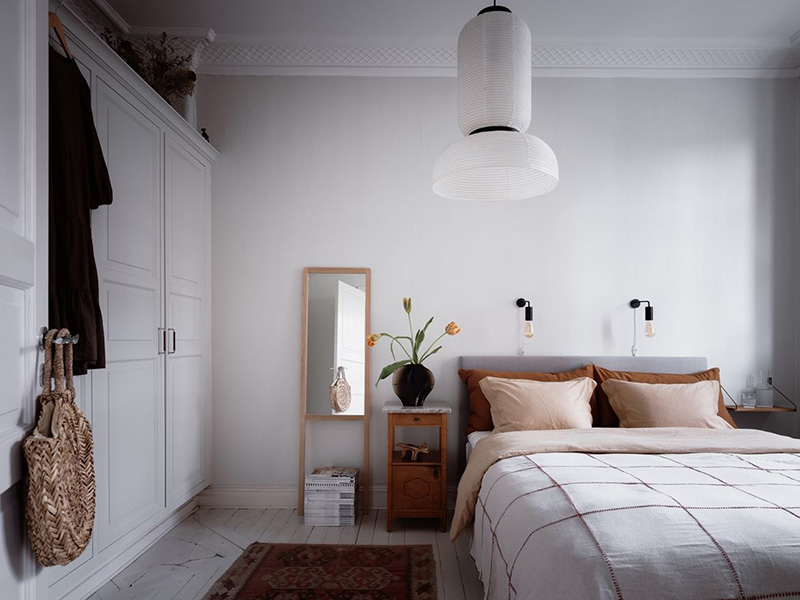 A large closet with vintage doors gives more storage space to the owners