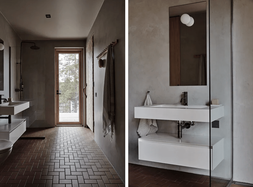 The bathroom is done with concrete, a brick floor and a door outside that is a window, too