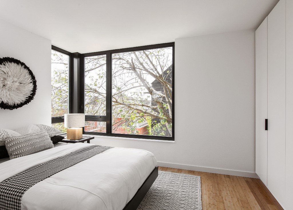 The bedroom is done in a monochromatic color scheme, printed textiles and a pretty artwork
