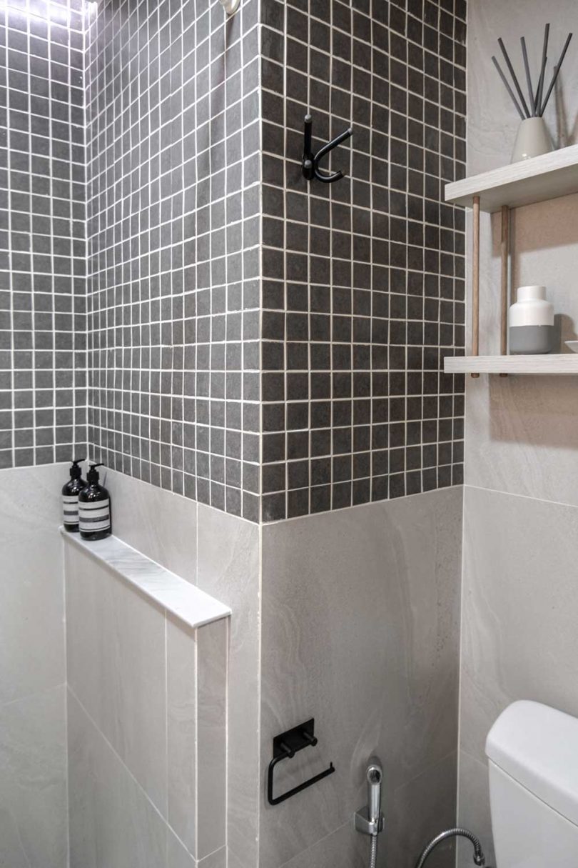 Even here a small storage shelf is hung over the toilet