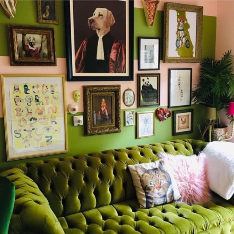 a bold maximalist living room with green walls and furniture, a gallery wall with bright artworks and potted plants