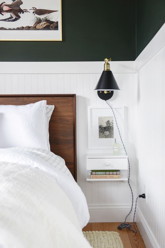 an elegant modern bedroom done in black and white, with rich stained furniture and cool floating nightstands