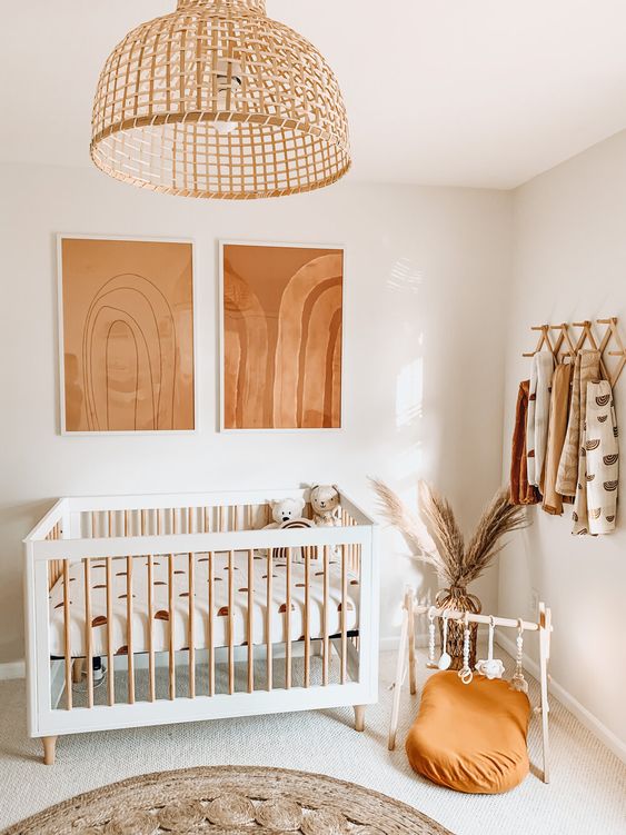 37 a neutral nursery with rust and orange touches, printed textiles, a rattan pendant lamp and pampas grass