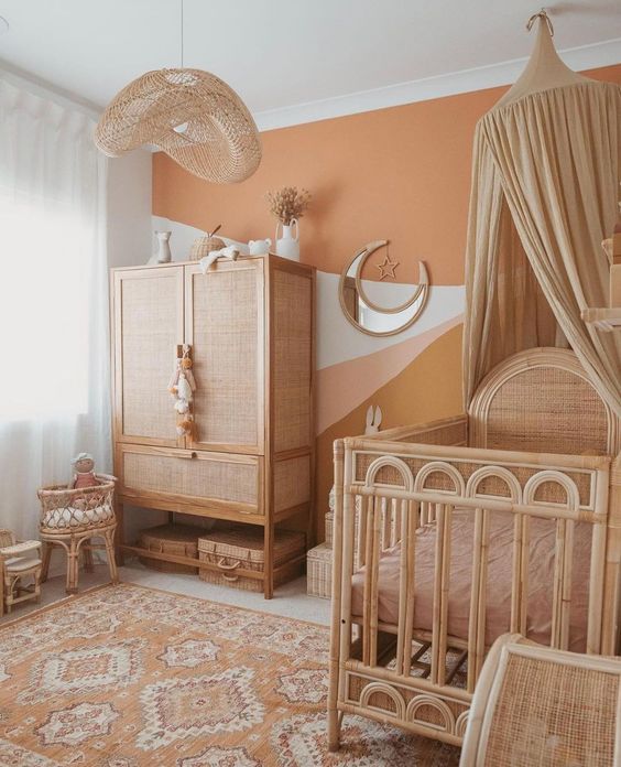 38 a very cozy earthy-toned nursery with a wall mural, rattan furniture, a neutral canopy and pastel bedding plus a catchy lamp
