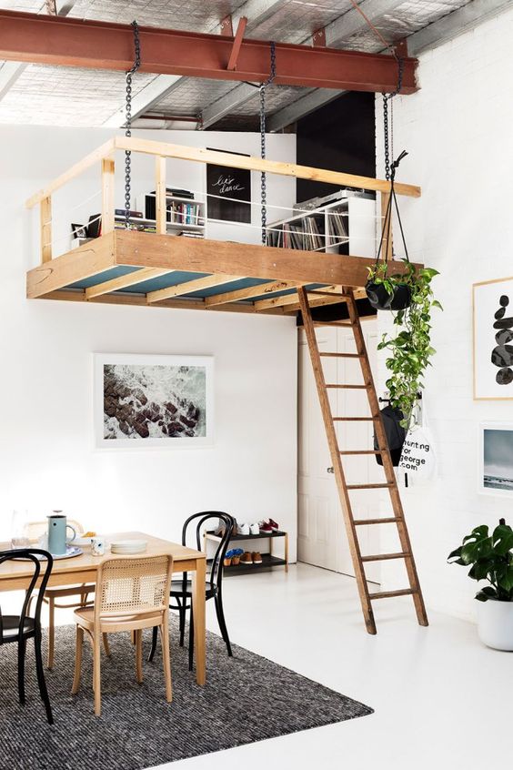 an eclectic apartment with a Scandinavian feel and a loft reading and working space with bookshelves is very cool