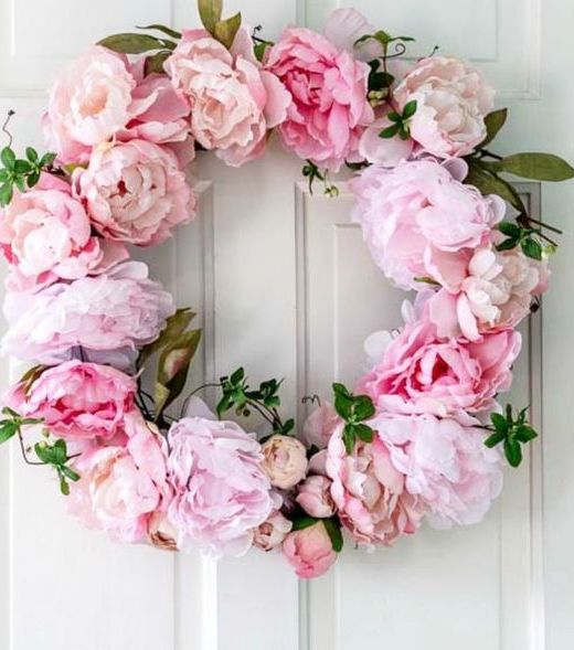 a pink peony wreath with greenery is a lovely idea that looks fresh and romantic and brings a touch of color