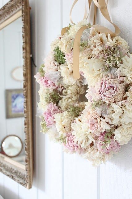 a simple pink, neutral and green bloom wreath and a neutral ribbon bow on top is a very long-lasting decoration