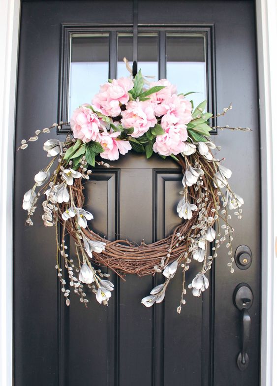 a vine wreath with pink peonies, faux greenery, some faux snowdrops is a pretty idea for a rustic space