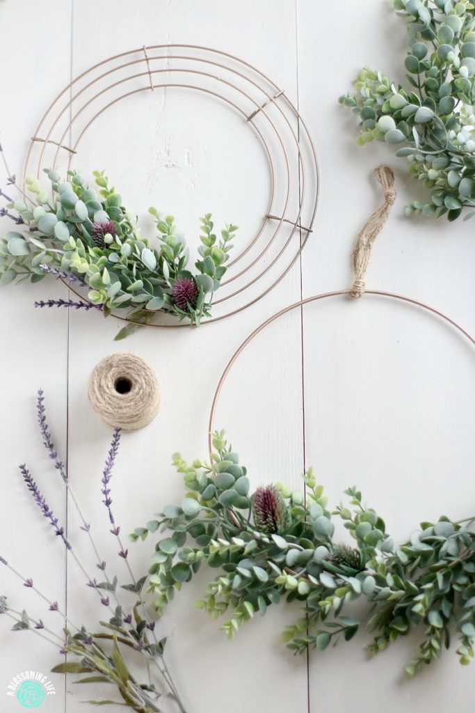modern spring wreaths of faux greenery and dried blooms will make your front door look fresh and edgy