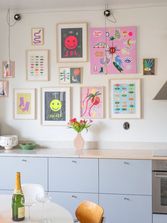 a bright and fun gallery wall with matching light stained frames and with no frames, with super bold artworks and posters