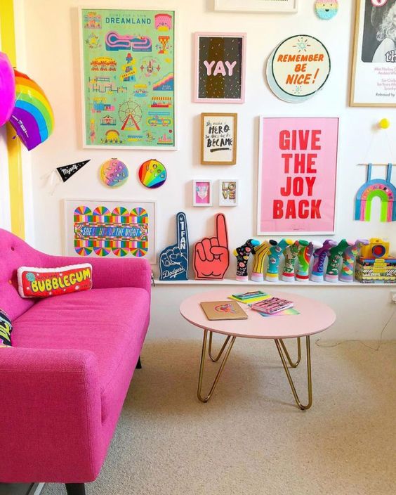 a bright pop art gallery wall with colorful artworks and posters plus bright decorative plates is a fun and chic idea with a bold look