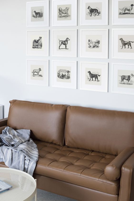 a catchy grid gallery wall with vintage dog pics is a unique solution and a great idea for a dog-lover home