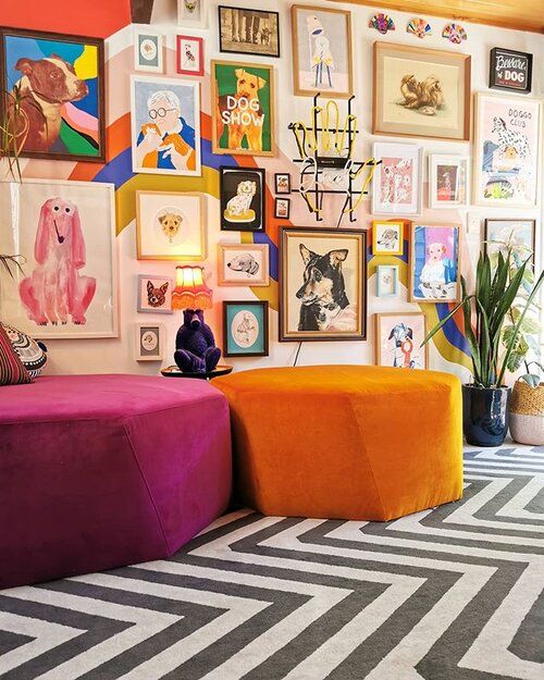 a colorful and bold gallery wall with mismatching frames and super bold artworks in various styles placed on a wall with color block