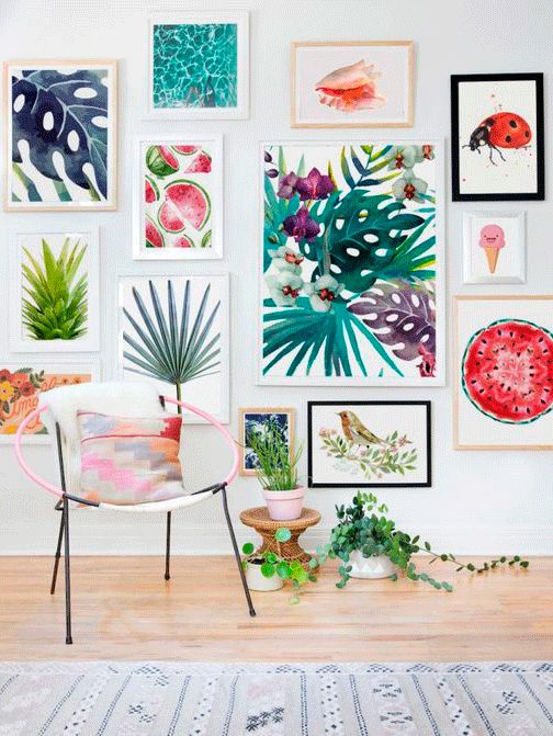 a fun and colorful gallery wall with a tropical theme, with prints and naive art in mismatching frames