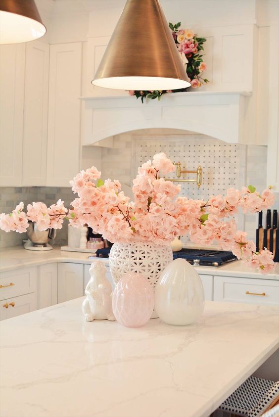 a laser cut vase with pink blooming branches is a very refined and chic centerpiece or arrangement for spring