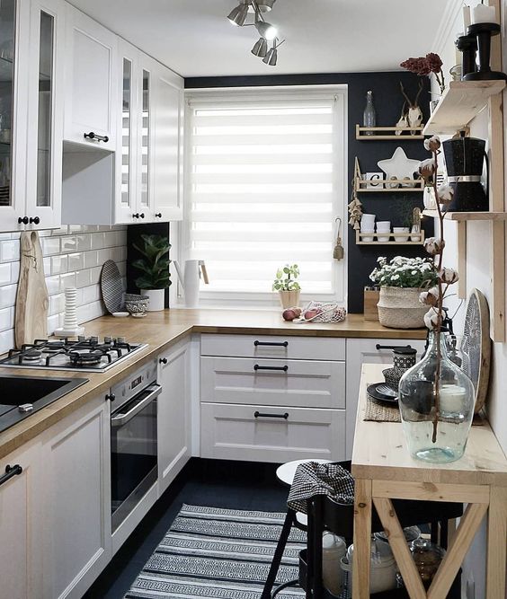 a lovely Scandinavian kitchen in black and white, with light-stained wood and enough light is cool