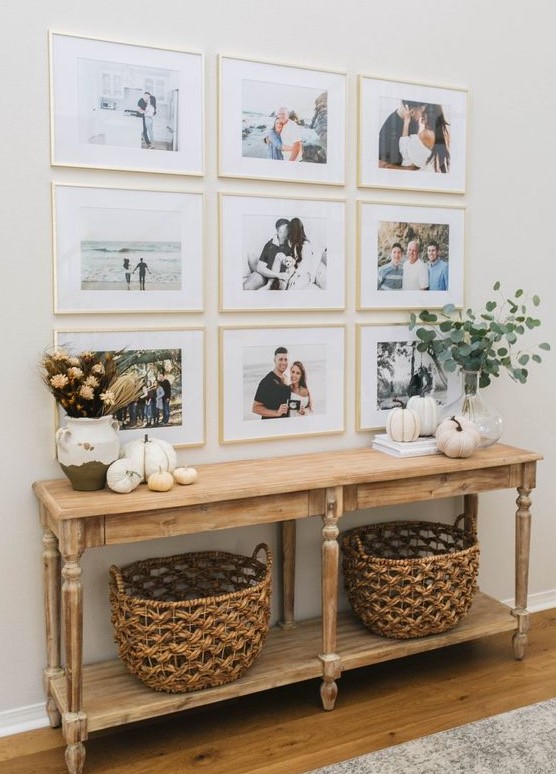 a modern grid gallery wall with matching gilded frames and colored family pics is a stylish idea to personalize your space