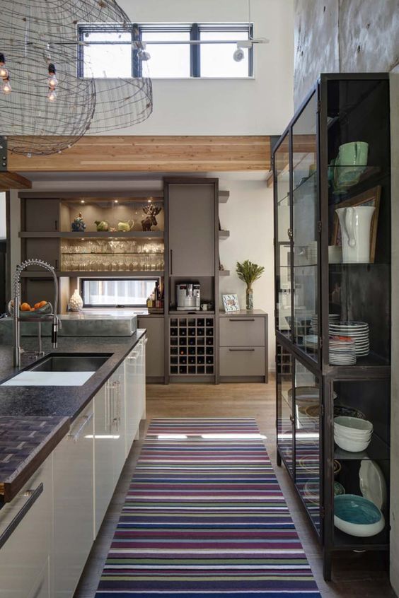 a modern home with elegant furniture, wooden beams, clerestory windows that bring more light inside this high ceiling space