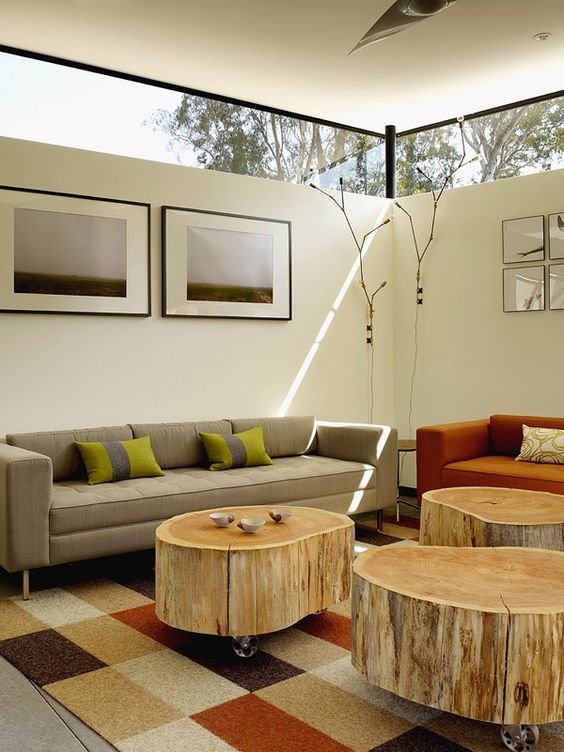 a modern living room with chic furniture and tree stump coffee tables plus clerestory windows for light yet privacy