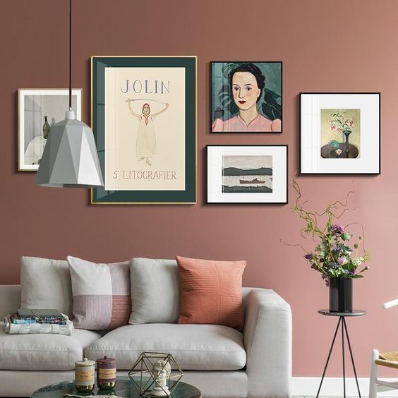 a simple yet catchy gallery wall with thin frames, colorful vintage art looks elegant and cohesive