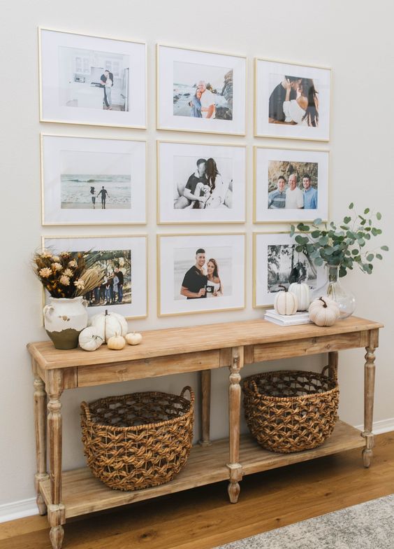 a symmetrical gallery wall with matching blonde wood frames and various family pics is always a good idea for any space
