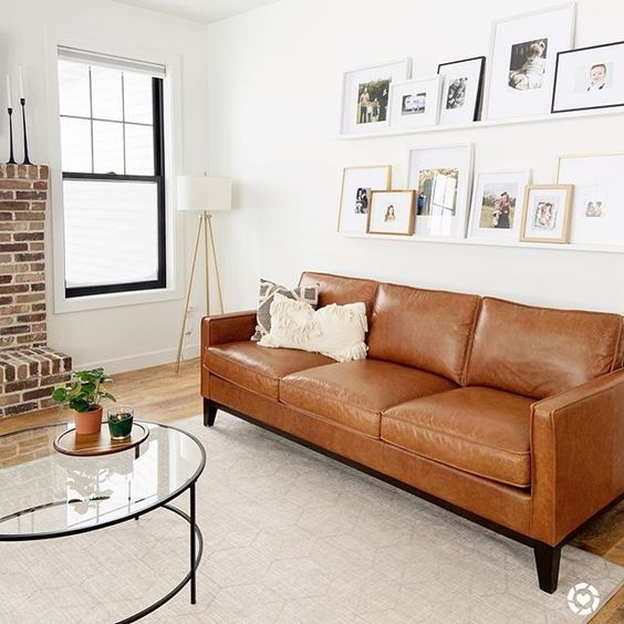 a white wall with white ledges that merge with it and various family photos that are placed chaotically and look cool