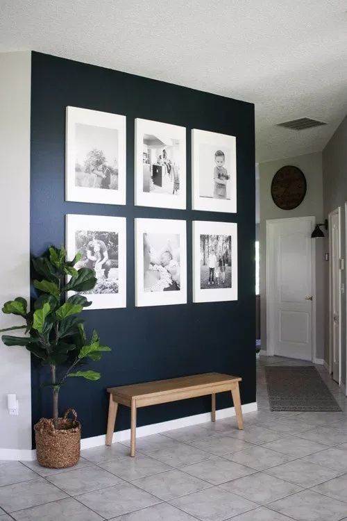 an awesome grid gallery wall with no frames, black and white photos and white matting is very chic and fresh