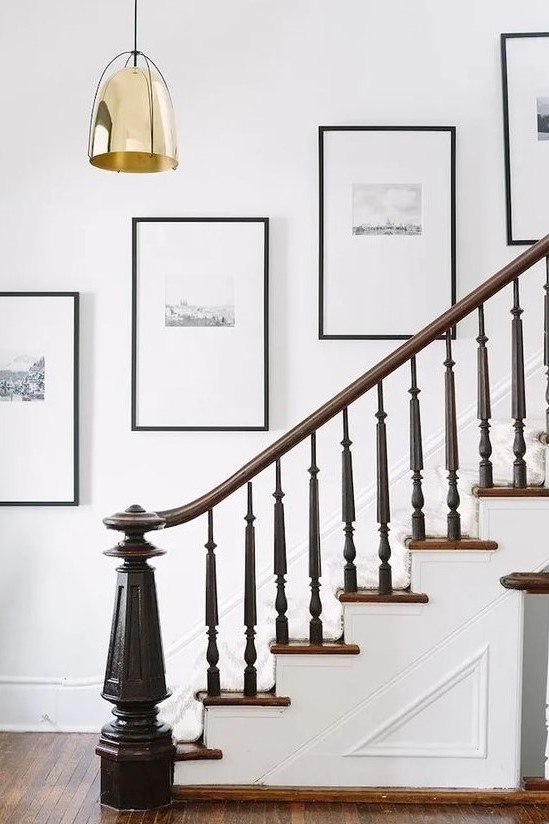 an elegant grid gallery wall with black and white artworks, matting and black frames is a super stylish idea