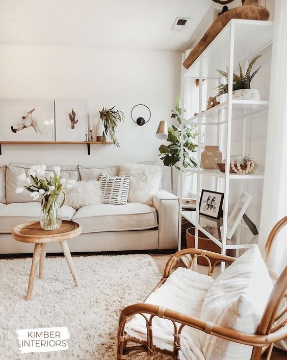 08 a neutral and cozy living room with a rattan chair, a neutral sofa, a large storage unit and lots of potted greenery