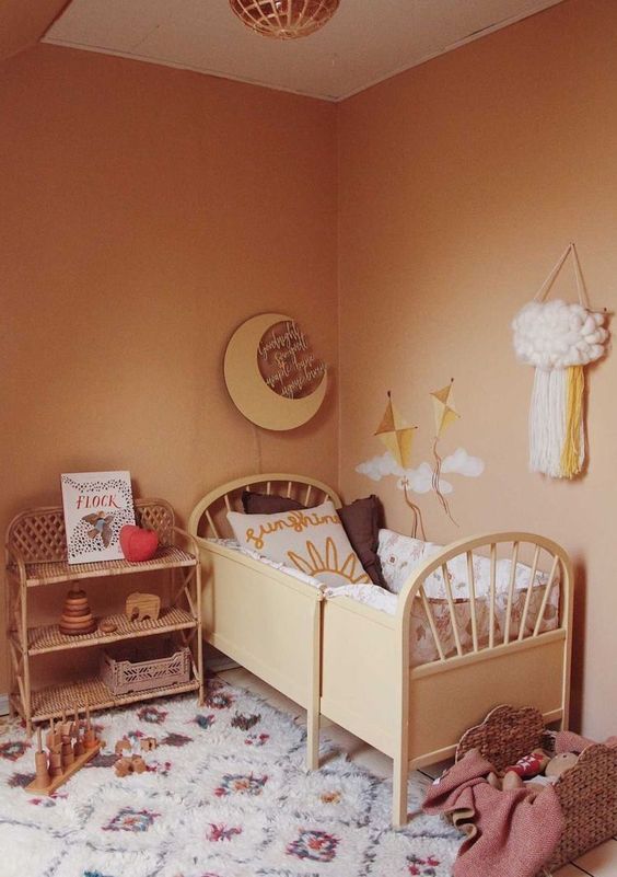 16 a warm earthy-tone kid’s room with warm-colored walls, stylish furniture, printed textiles and lots of toys