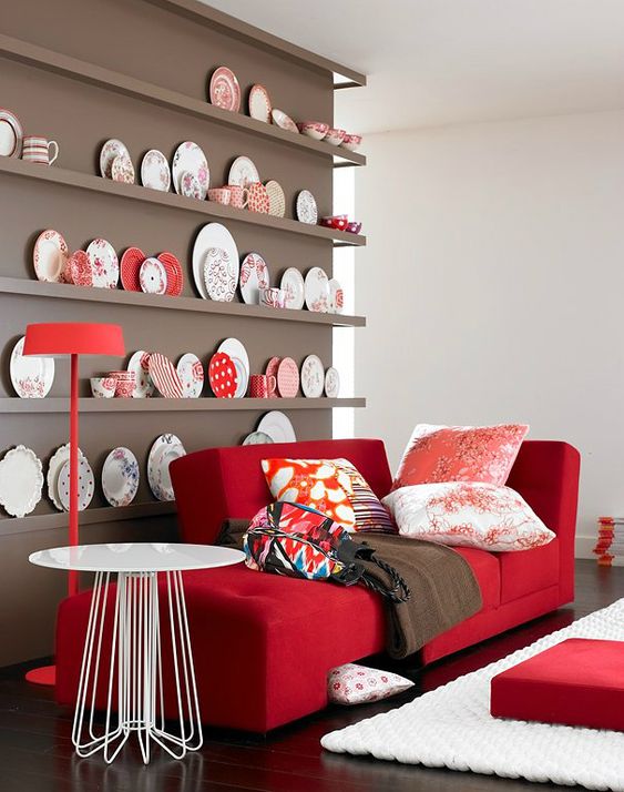 https://www.digsdigs.com/photos/2021/04/a-chic-nook-with-a-taupe-wall-and-a-collection-of-decorative-plates-a-red-couch-and-printed-pillows-plus-a-round-table.jpg