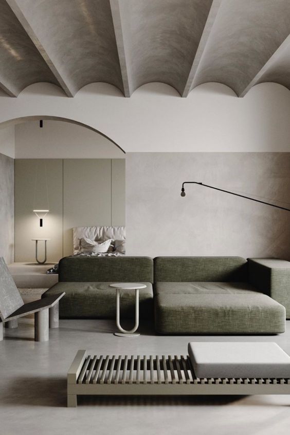a minimalist living room with a grey ceiling, a green low sofa, a daybed, some chairs and laconic lamps