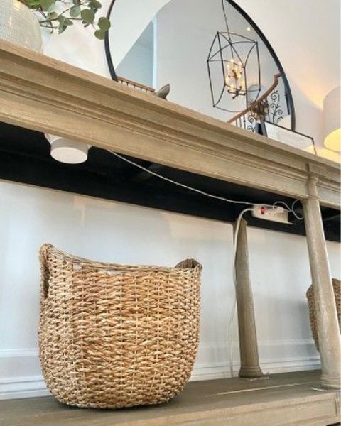 a basket placed under a console table is a lovely way to hide your router or you can attach it to the tabletop as cables