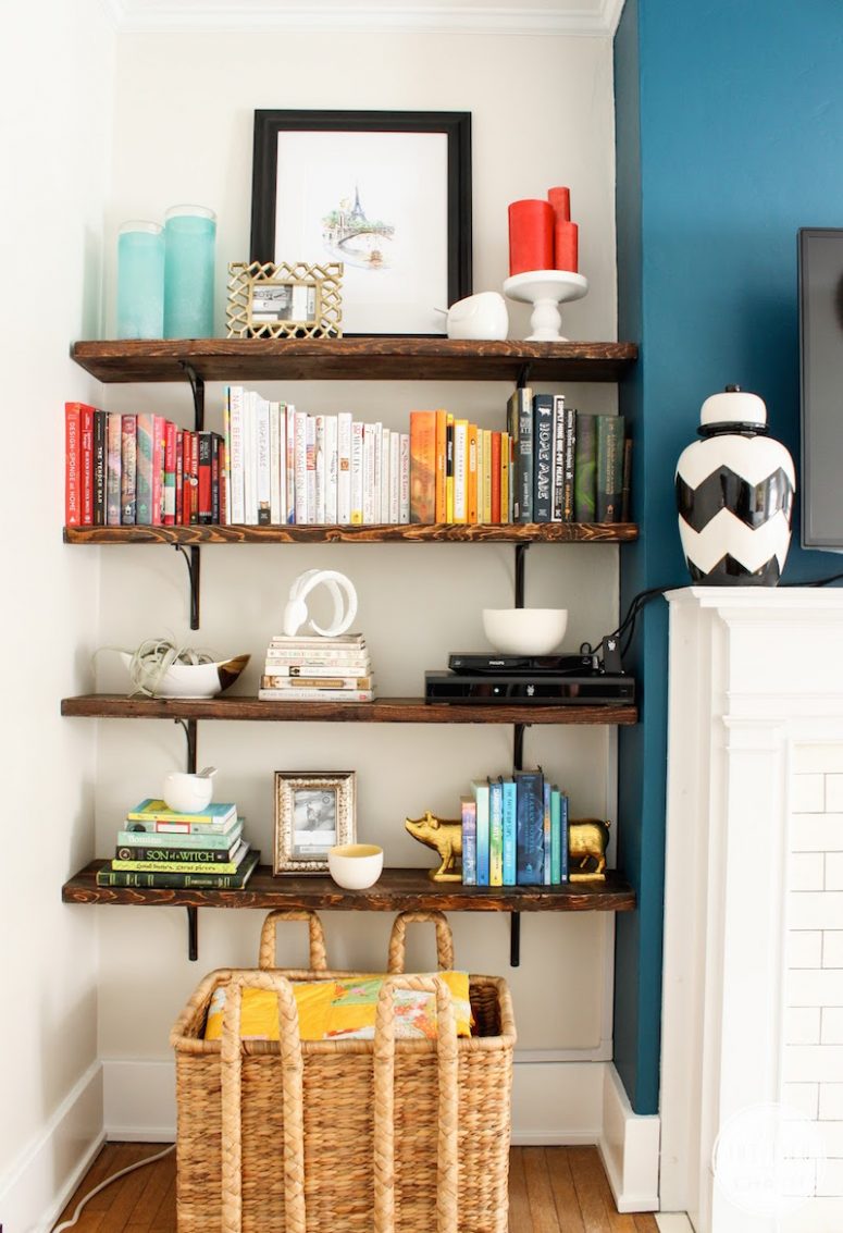 a router placed on a shelf makes part of decor like stacked books is a lovely idea to hide it right in the sight