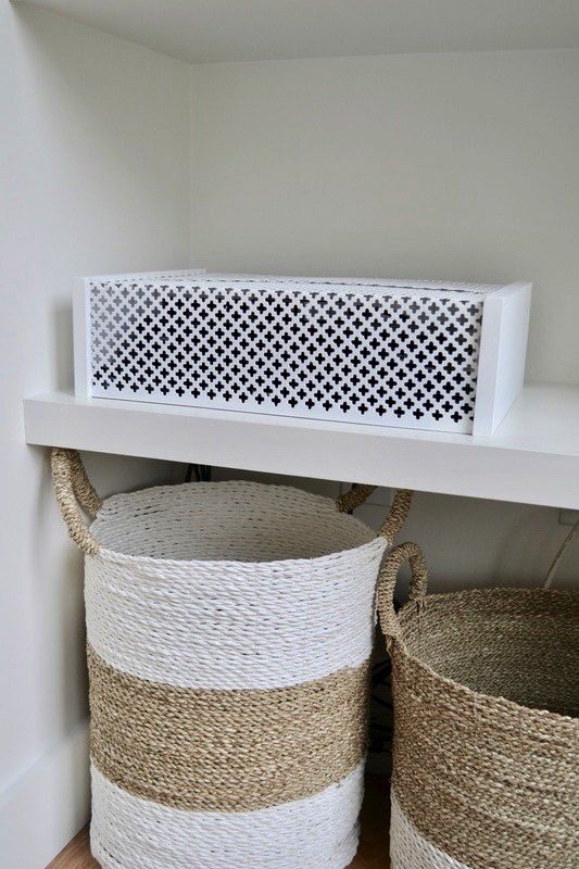 an elegant laser cut box for hiding your wi-fi router is a great idea to hide what you don't need to see every time