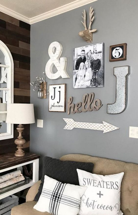 a chic farmhouse gallery wall with monograms, an ampersand, calligraphy, arrows and a family pic in the center