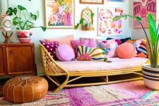 a colorful living room with bright rugs, a bright gallery wall, a colorful sofa with pillows and potted plants