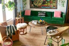 a colorful maximalist living room with a tile floor, a green sofa and rattan furniture, colorful pillows and rugs and potted plants