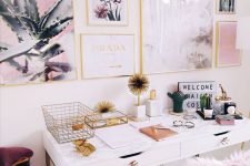 a fancy and glam home office with a white desk, a gold chair with pink faux fur, a lovely glam gallery wall in gold frames