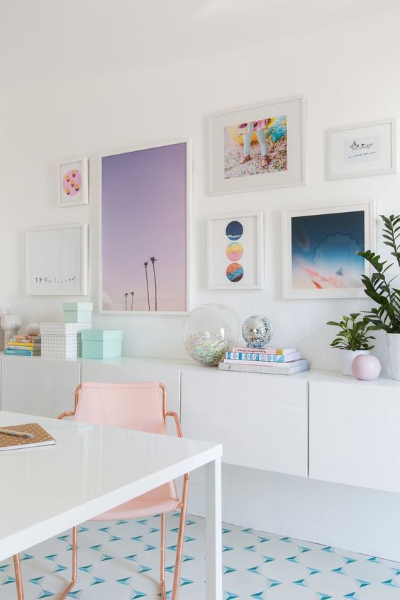 a home office with a cheerful gallery wall