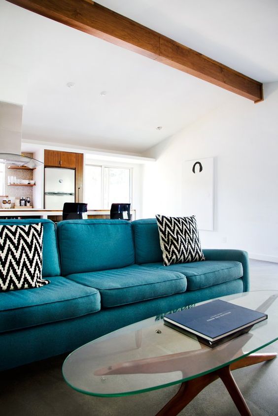 a cozy living room with exposed wooden beams