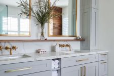 16 a light grey bathroom done with kitchen cabinets, a white stone countertop and a backsplash, a double sink and mirrror is super chic