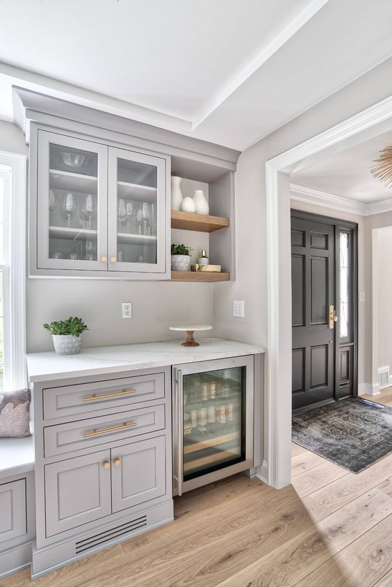 a light grey home bar done with kitchen cabinets, open shelves and a wine cooler is a lovely space for a farmhouse home