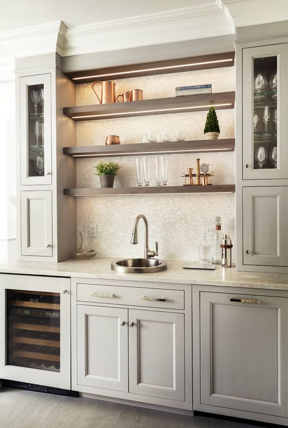 a large home bar done with neutral kitchen cabinets, with a large tile backsplash, open shelves, a wine cooler and additional lights
