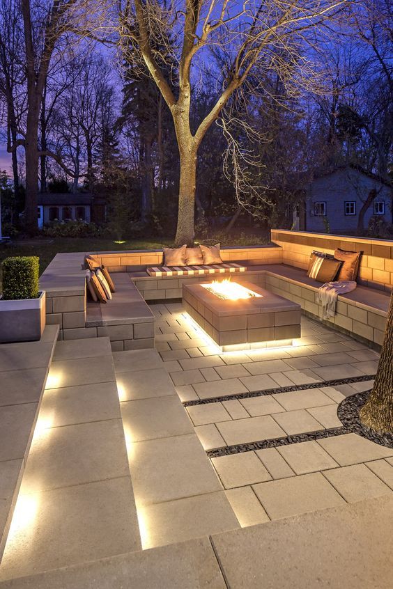 a beautiful sunken pation with built in lights, a fire pit and lots of pillows invites to spend time here