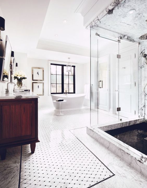 a spacious bathroom with a glass-enclosed shower space