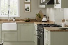 a modern country kitchen in olive green, with grey walls, butcherblock countertops and lovely botanical prints is a lovely idea