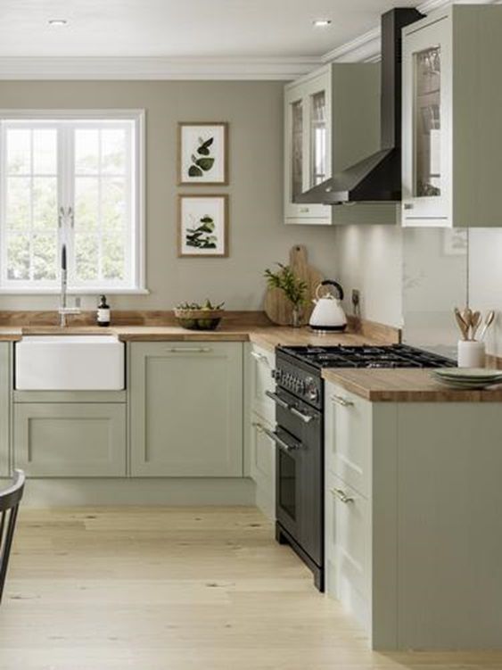 a modern country kitchen in olive green, with grey walls, butcherblock countertops and lovely botanical prints is a lovely idea
