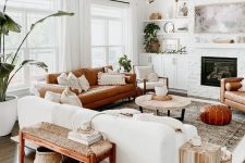 10 a welcoming mid-century modern living room with a built-in fireplace, a white and rust-colored sofa, a woven bench, potted plants